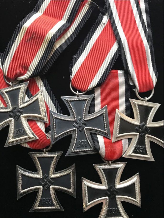 Classic WWII German Iron Cross medal with ribbon, displayed and certified