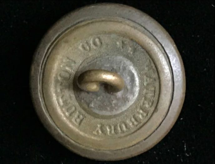 Close-up of Civil War Union eagle button in a museum collection