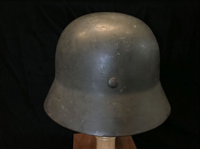 Detailed view of the WWII German Field Police M-35 helmet, certified and displayed at the museum