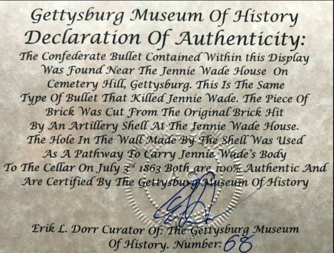 Jennie Wade House brick and Confederate bullet relics displayed in a collector's case at the museum