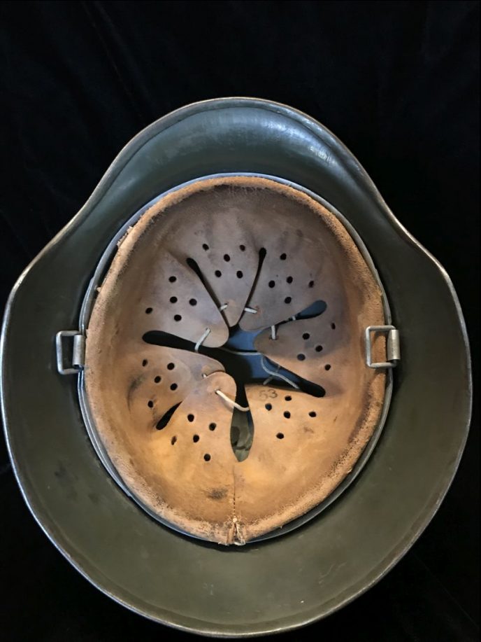 Side profile of the original WWII German M-35 helmet with Field Police decals, brought back by a U.S. veteran