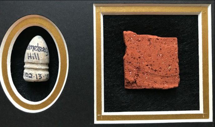 Display case featuring a brick from Jennie Wade House and a Confederate bullet from the Battle of Gettysburg