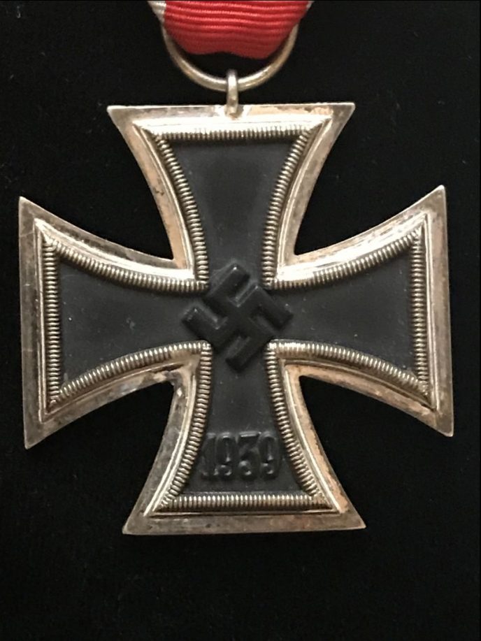 Detailed shot of WWII Iron Cross medal on display, certified by Gettysburg Museum