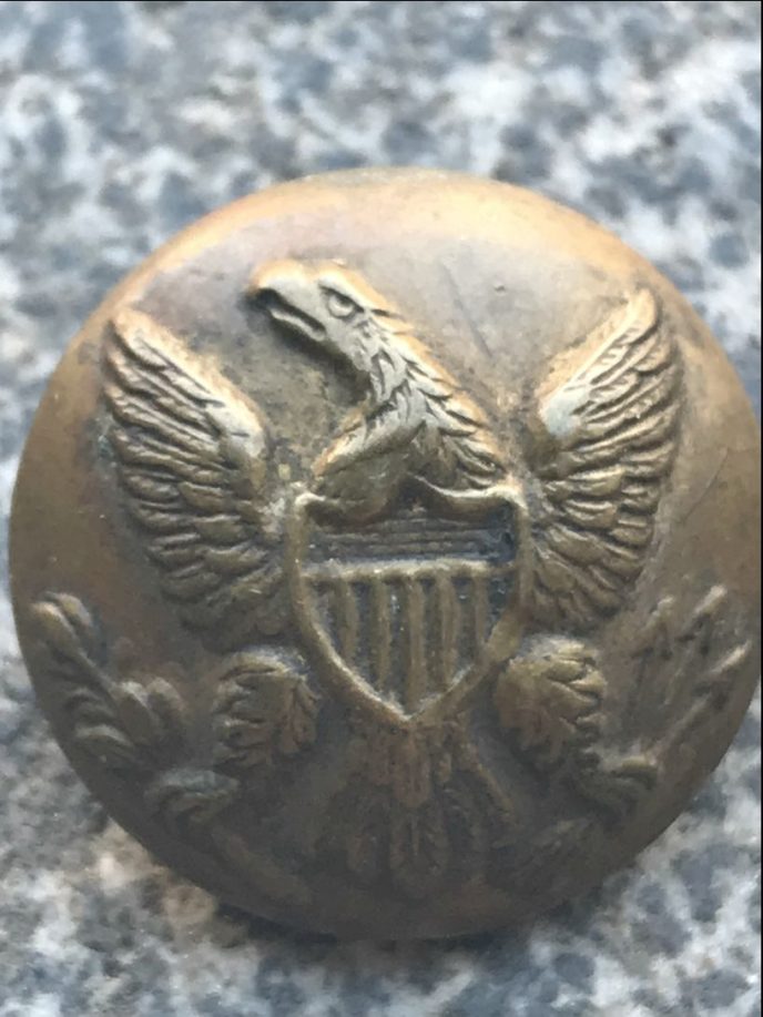 Original Civil War relic, Union eagle coat button, displayed in a glass case