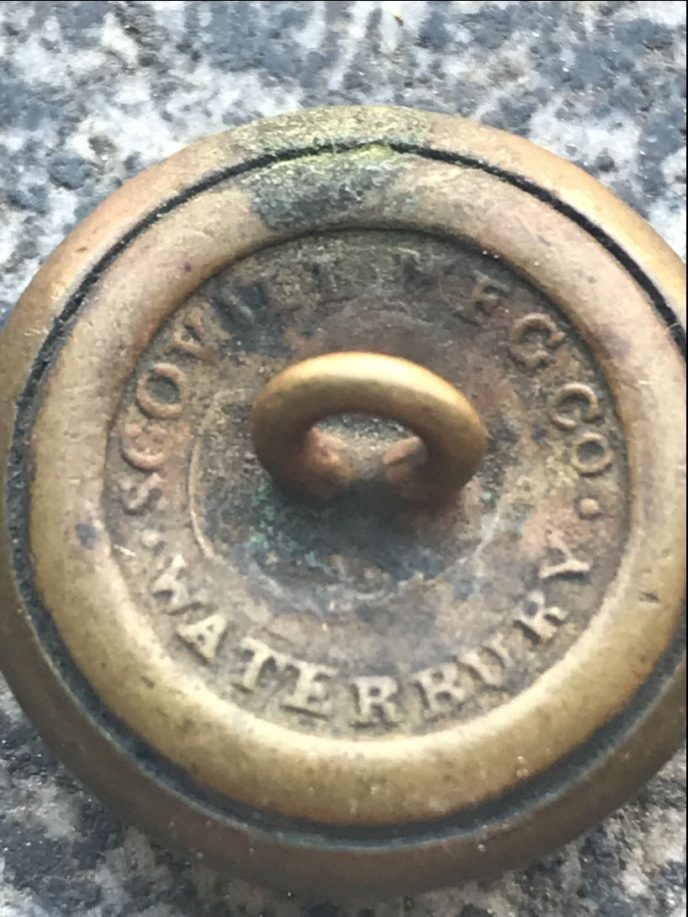 Close-up of Civil War Union eagle coat button in museum display