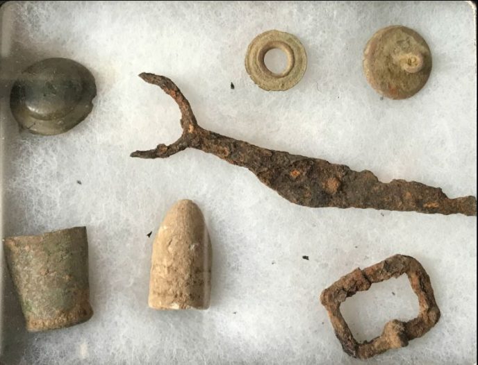 Civil War relics collection from Virginia excavation displayed in a museum case