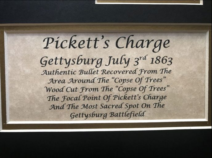 Display of battlefield wood and bullet relics from Picketts Charge