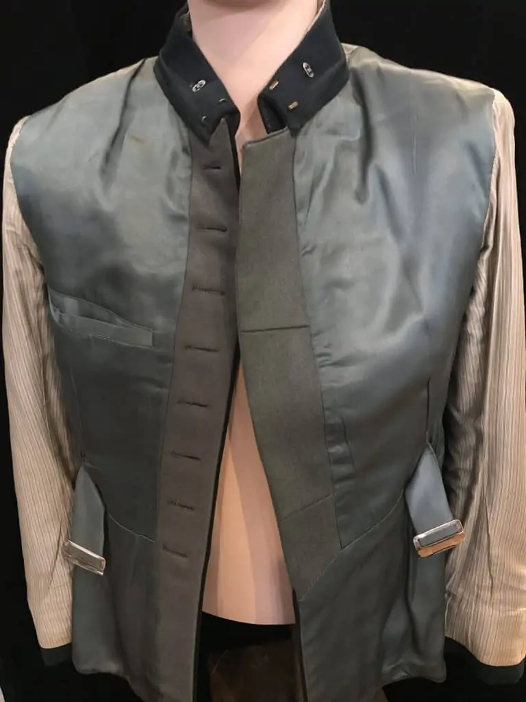 Close-up view of WWII German Der Spiess uniform with full insignia, on display