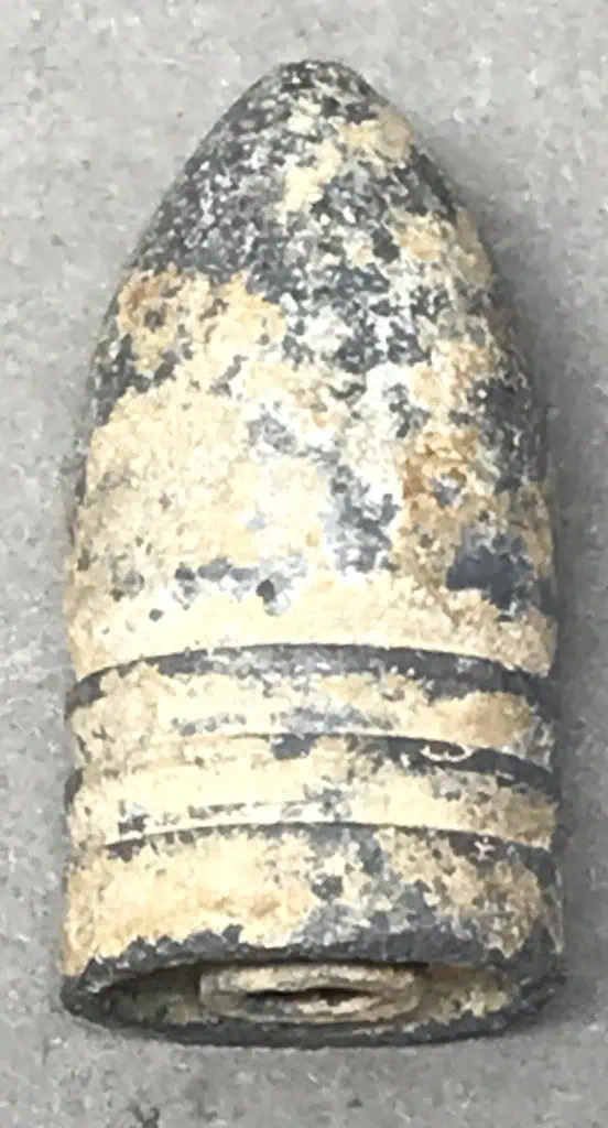 Side view of Civil War explosive bullet with certification